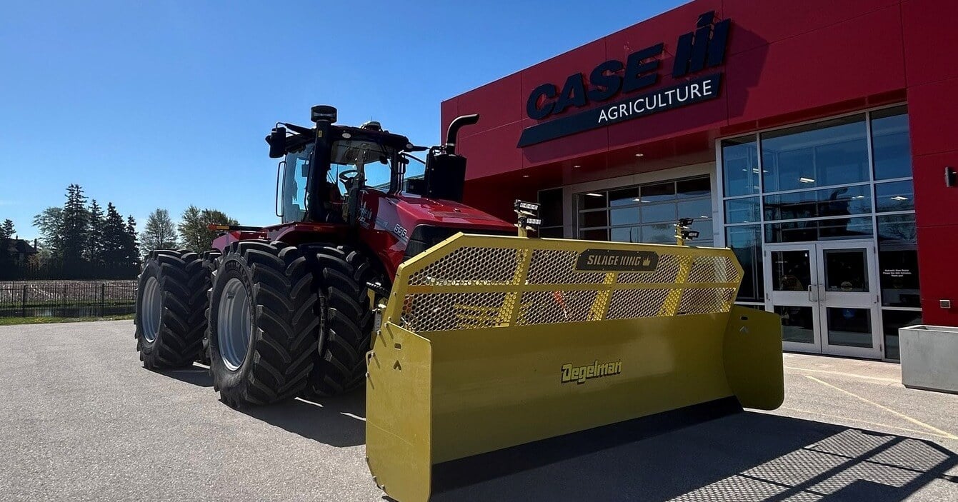 Case IH 555 tractor with a Degelman Silage King blade