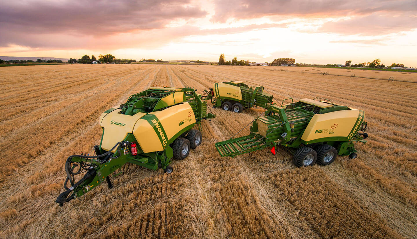 Krone balers in a wheat field